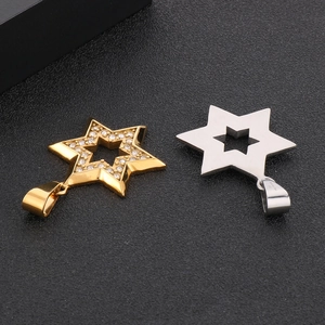 Close-up of gold and silver hexagram pendants with inlaid zircons and hollow back