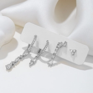Elegant silver earring set with pear-cut and marquise zircons on white silk background