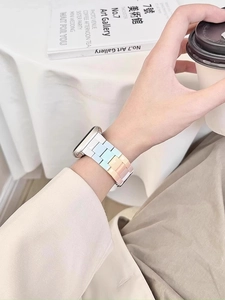 Detail of macaron gradient resin watch strap for Apple Watch in casual lifestyle setting