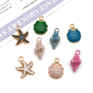 Colorful enamel ocean charms set featuring shell and starfish alloy pendants on white background