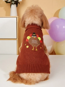 Detailed close-up of brown knit dog sweater with embroidered festive turkey pattern