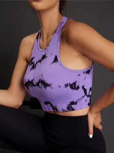 Detail of seamless tie-dye ribbed sports bra showing purple knit texture and racerback design