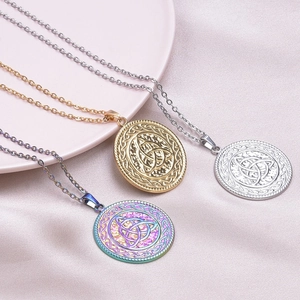 Three stainless steel witch knot necklaces in gold, silver, and rainbow on pink satin