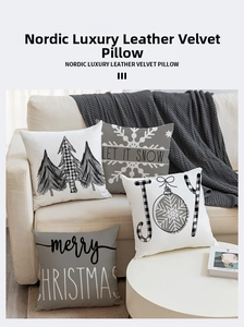 Close-up of linen Christmas pillow covers featuring Let It Snow and Joy text designs
