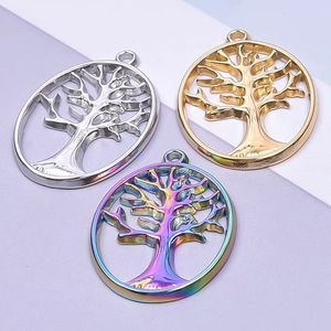 Three tree of life pendants in silver, gold, and rainbow finishes on minimalist background
