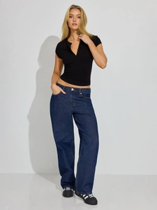 Slim fit V-neck button top paired with dark blue wide leg jeans and black sneakers