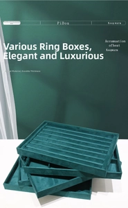Macro view of stackable dark green velvet jewelry trays with multiple ring display slots