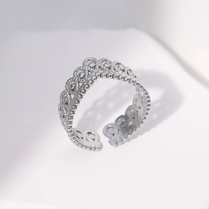 Detail of silver crown crown ring showing hollow wave pattern and adjustable band