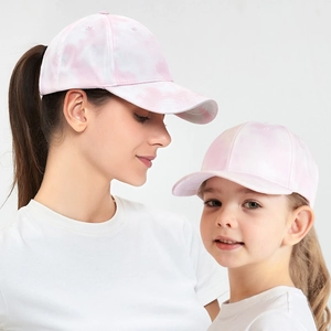 Detail of pink tie-dye ponytail baseball caps for mother and child in outdoor style
