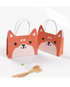 Detail of kindergarten graduation gift bag featuring cute cartoon Shiba Inu print with handles
