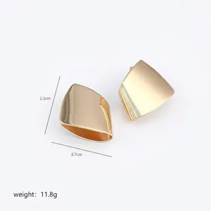 Detailed view of irregular polished gold stud earrings with dimensions 2.3cm by 2.7cm