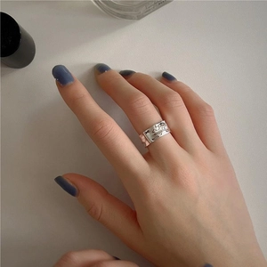 Detailed view of minimalist irregular texture S925 sterling silver wide ring on finger