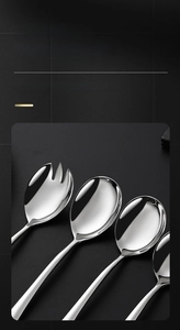 Detail of mirror-polished 304 stainless steel serving spoon and salad fork with metallic shine