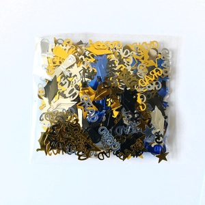 Blue and gold graduation party confetti featuring graduation caps, stars, and GRAD text