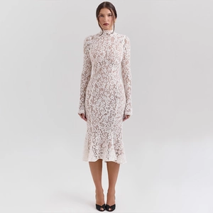 Detailed view of the intricate lace texture and fishtail hemline on this white midi dress