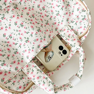 Detail of floral canvas bag showing stitching, tulip patterns and interior storage space