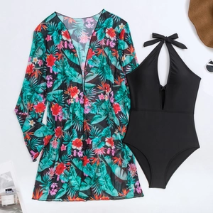 Detailansicht eines schwarzen V-Ausschnitt-Badeanzugs und tropischen Blumen-Strandkleids