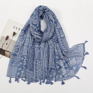 Close-up of blue paisley printed scarf with fringe tassels and soft linen texture