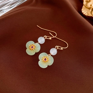 Elegant Chinese style resin jade flower earrings with gold hooks on silk background