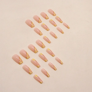 Long trapezoid press-on nails featuring yellow French tips and glittery gold lines