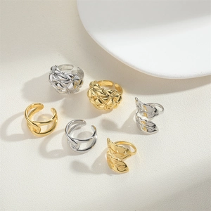 Detail view of 14K gold and silver rings in crossover, mesh and leaf designs