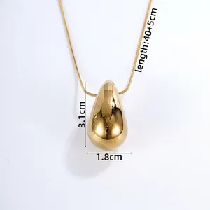 Macro shot of gold teardrop pendant necklace with dimensions 3.1x1.8cm on snake chain