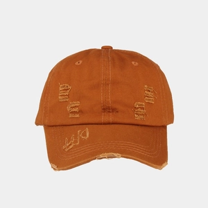 Detail of washed cotton baseball cap with distressed rips and OFF embroidery on brim