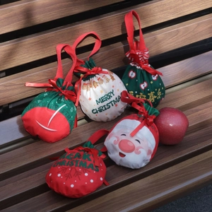 Christmas drawstring gift bags with Santa Claus prints and festive Merry Christmas text
