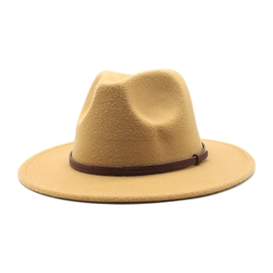 Detail of khaki fedora hat featuring a brown textured faux leather band and flat brim