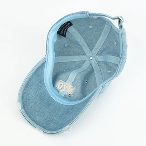 Detail view of cotton denim baseball cap with interior sweatband and distressed brim finish