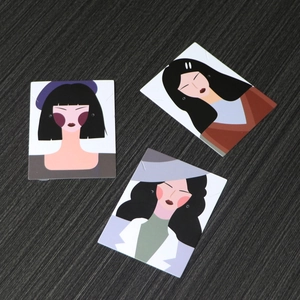 Three premium illustrated cardstock display cards for earrings and necklaces on wood