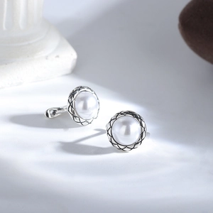 Retro s925 silver button pearl stud earrings with vintage diamond pattern on white pedestal