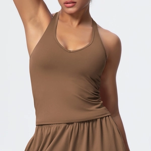 Close-up of deep brown V-neck sports top and high-waisted shorts on a fitness model