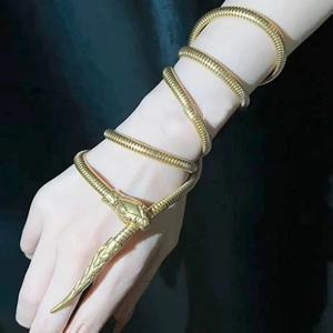 Elegant gold snake-shaped metal chain accessory worn as a stylish arm wrap jewelry piece
