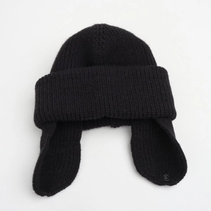 Solid black knitted earflap beanie for kids featuring thick yarn and button details