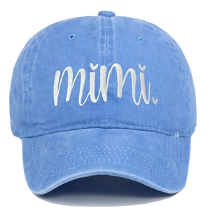 Detailed view of white mimi embroidery on a blue washed cotton vintage baseball cap
