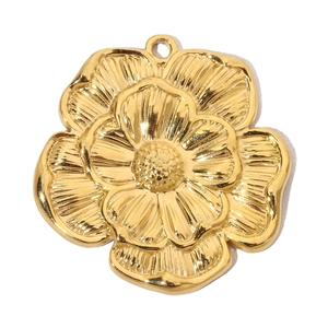 Detailed macro view of golden vintage flower pendant with brushed metal texture and petal layers