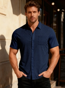 Close-up of navy short sleeve shirt featuring geometric waffle texture and buttoned lapel
