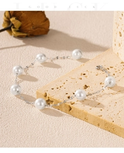 Detailed macro shot of an elegant S925 silver pearl bracelet on a textured stone surface