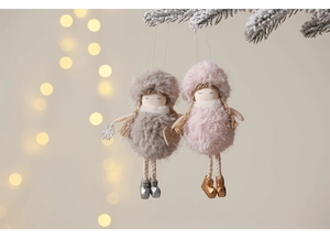 Detail of plush angel ornaments with faux fur and embroidery on Christmas tree branches