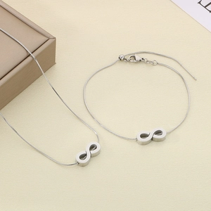 Detail of silver infinity symbol necklace and bracelet set with sleek snake chain design