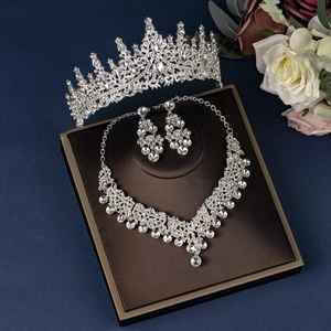 Exquisite bridal jewelry set with sparkling crystals and crown on a display stand
