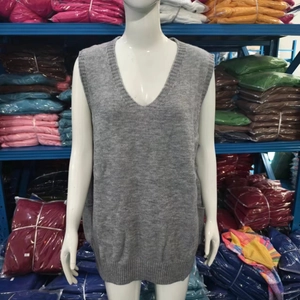 Detail view of the V-neckline and fine knit texture of this grey sleeveless sweater vest