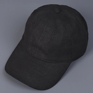 Detailed top view of a black linen baseball cap showing breathable holes and stitching