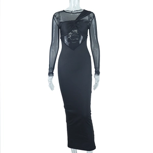 Detail of sheer mesh patchwork and twist knot detail on a slim-fit black dress