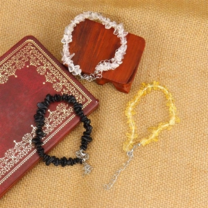 Detailed view of handmade adjustable bracelets with natural white, black and yellow crystals