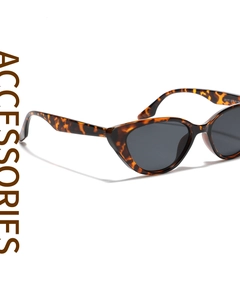 Close-up of leopard cat-eye sunglasses featuring tortoiseshell frames and grey lenses