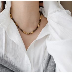 Close-up of 18k gold-plated beaded necklace with vintage brown tiger eye stones