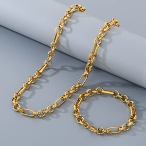 Dettaglio set collana e bracciale in acciaio al titanio dorato con maglie testurizzate 3:1