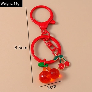 Detail showing red cherry keychain dimensions: 8.5cm length, 11g weight, 2cm charm width